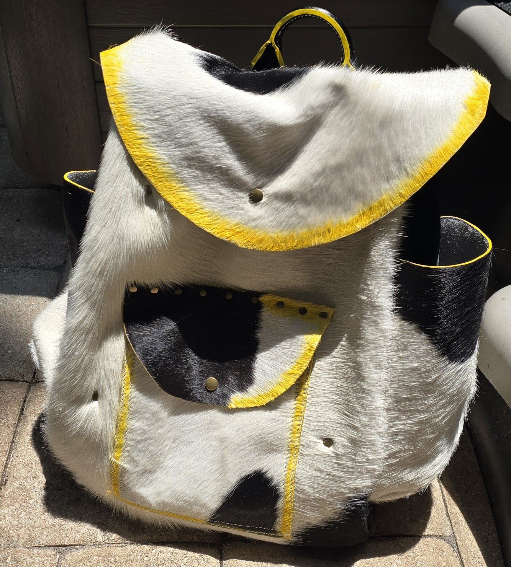 handmade leather black and white fur overnighter backpack with yellow accents bbk leather designs