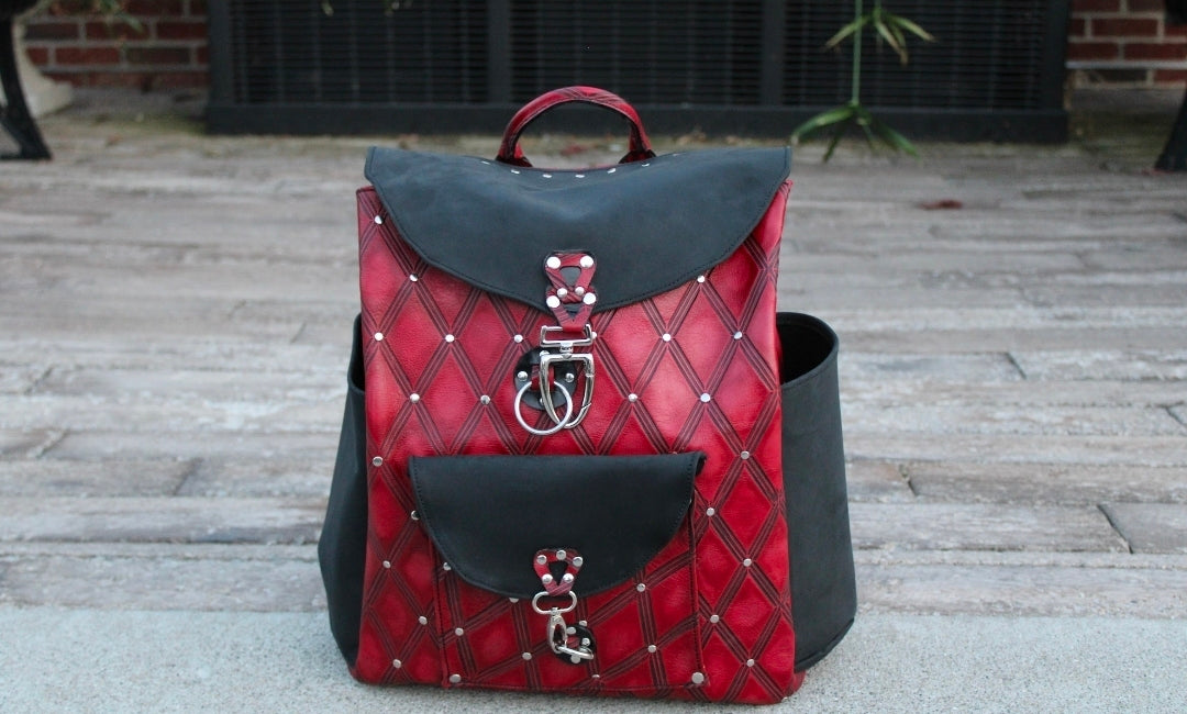 handmade leather red diamond overnighter backpack with rivet accents and black flaps bbk leather designs